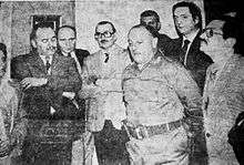 Black-and-white photo of Kirchner and other local politicians