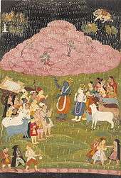 The mountain Govardhan hovers above Krishna and his tribe to protect them from an air attack