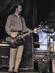 Novoselic playing bass guitar on stage