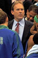 Kurt Rambis in front of Timberwolves players.
