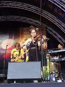 Kyla-Rose Smith playing violin onstage with Freshlyground at the Rheingau Musik Festival on 11 August 2012