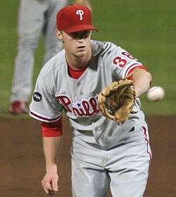 Kyle Kendrick about to catch a ball with his gloved hand
