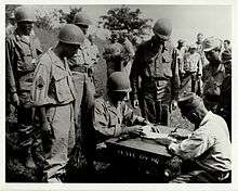 Lt. Col. Sylvester Del Corso, commander of the 1st Battalion, 145th Infantry, receives the surrender of Japanese forces on the Philippine Island of Luzon
