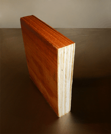 A short piece of laminated veneer lumber cut in section to show composing multiple layers of thin wood