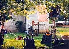 Laura Leighton sets up the bottles to be shot down while filming "In the Name of Love: A Texas Tragedy"