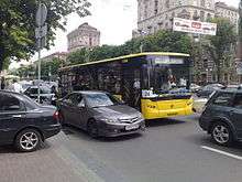 Black-and-yellow bus in traffic