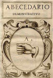 a scan of the cover of a historic book, it shows some Spanish text and a drawing of a hand forming a sign