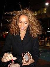 Colour photograph of Leona Lewis signing an autograph in 2006.