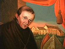 A painting of a priest with thin brown hair facing his left in front of a parted curtain that reveals a series of buildings in the background.