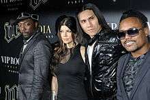 will.i.am, Fergie, Taboo and apl.de.ap standing in a row, all wearing black clothing.