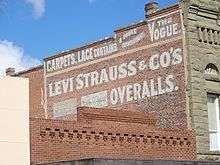 photo of an advertising sign for Levi Strauss & Co. painted on a brick wall in Woodland, California