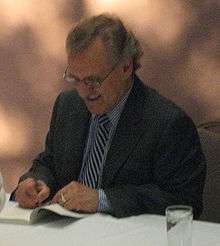 Author Stephen Lewis signs a copy of the book's second edition