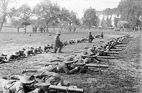 Soldiers on a firing line operating Lewis guns