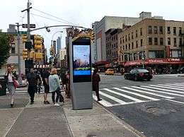 A LinkNYC kiosk at 23rd Street and Eighth Avenue, with side advertising panel