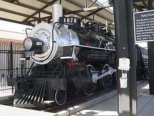 Steam locomotive in roofed outdoor enclosure