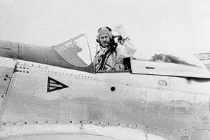 Man in flying suit in the cockpit of a single-seat fighter