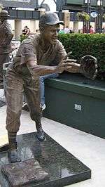 At U.S. Cellular Field, a bronze statue depicts a baseball player stepping on the base and leaning forward to catch a baseball being flipped to him.