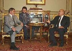 Photograph of Nabil Shaath sitting with President Lula da Silva of Brazil, speaking