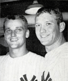 Two men in pinstripe baseball uniform with an interlocking "NY" partially showing at the bottom.
