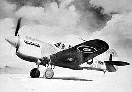 Single-engined military monoplane on desert airfield
