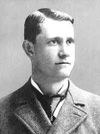 Black-and-white photo of Ed Delahanty in a suit, facing right