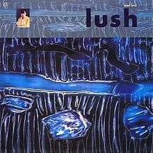 An abstract painting featuring black-and-white lines and alternating shades of blue. In the top-left corner there is a photograph of a woman; in the top-right corner black lowercase text reads "Lush" and yellow lowercase text above it reads "Mad Love".
