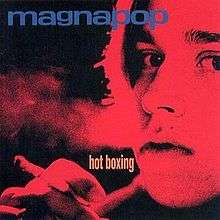 A close-up on the face of a woman who is holding a cigarette in her right hand and exhaling smoke. The photos is tinted red and has "magnapop" written in blue along the top and "hot boxing" written in yellow toward the center.