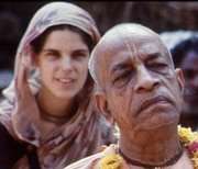 A color photo of a young Western woman dressed in sari and an Indian Swami in the forefront