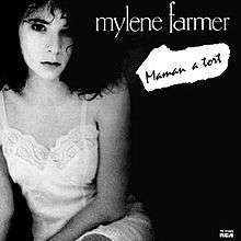 Photo depicting at the left Mylène Farmer who is wearing a white nightgown, on a black background