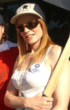 Woman in white knit blouse with hat, sunglasses and red hair