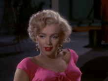  Monroe in Niagara. A close-up of her face and shoulders; she is wearing gold hoop earrings and a shocking pink top.