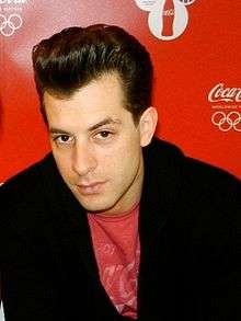 Mark Ronson wearing red t-shirt with a black jacket.