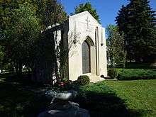 White stone mausoleum with iron doors and "Mars" engraved near the top