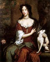 An informal portrait of Mary. She has a long handsome face, dark eyes and black hair. Her hair, her brown satin dress and plain linen undergarment are in fashionable disarray. She clasps a white dog.