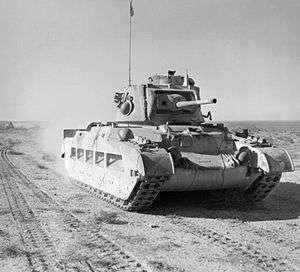 A tank moves across the desert