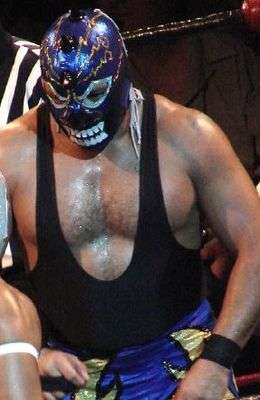 Mephisto, wearing a mask with spikes down the middle of his forehead, in the middle of a match.