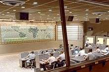 A look inside the Mercury Control Center, Cape Canaveral, Florida. Dominated by the control board showing the position of the spacecraft above ground