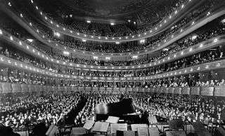 interior of huge 19th century opera house looking from the stage towards the audience seats