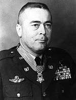 A black and white image showing the head and torso of Novosel in his military dress uniform with ribbons. His Medal of Honor is visible around his neck.