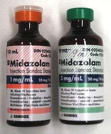 Two 10-ml bottles labeled Midazolam  - the bottle on the left has a label in red and says 1 mg/ml; the one on the right is in green and says 5 mg/ml. Both bottles have much fine print.