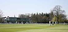 Cricket being played in front of the pavilion at Millfield School