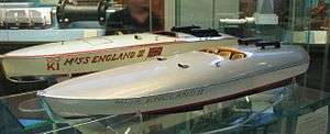 Two models of speedboats are displayed in a glass cabinet, the nearest model has Miss England II painted on the side, the other, Miss England III