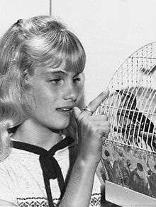 Julie Anne Haddock, age 12, with a bird in a birdcage.