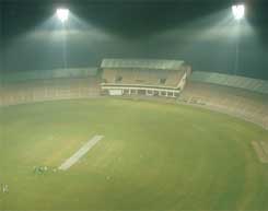 A view of a cricket ground at night.