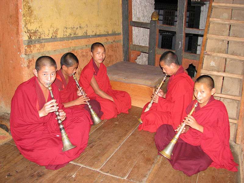 Monks playing lingm at Lhuentse Dzong