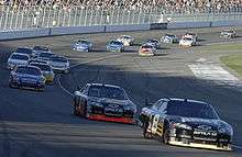 Nineteen cars photographed driving on the front stretch of the Las Vegas Motor Speedway