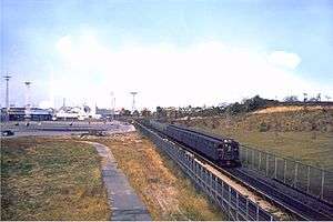 A train operating on the World's Fair railroad line in the middle of a field