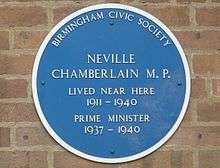 Blue plaque on a brick wall