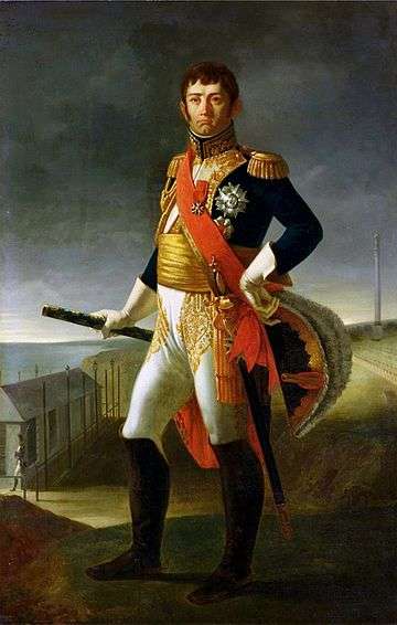 Painting of a standing man with a bicorne hat in his left hand and his right hand holding a marshal's baton. He wears a dark blue military coat with much gold braid, white breeches, black knee boots and a red sash across his chest. His face has a cleft chin and a stern look under dark hair.