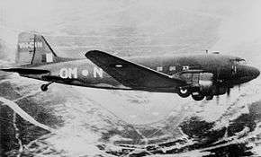 Side view of twin-engined military place in flight